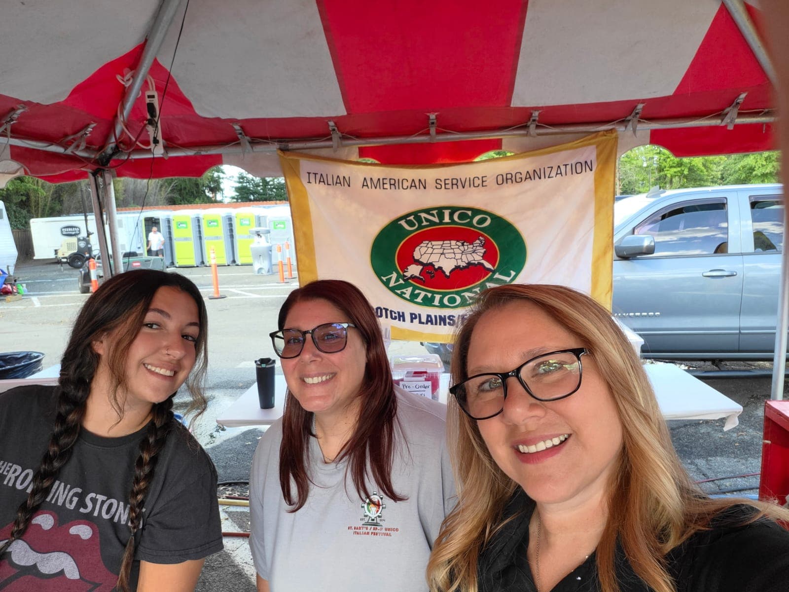 Festival volunteers welcome visitors at the Scotch Plains-Fanwood UNICO booth.