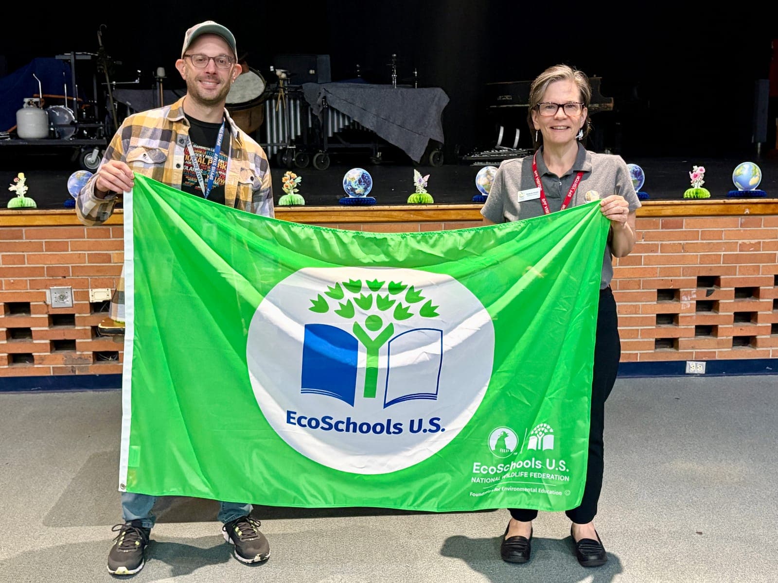 From left, SPFHS Environmental Club advisor Zachary Rittner and Dr. Roberta Hunter of NJ Audubon hold the club’s Green Flag.