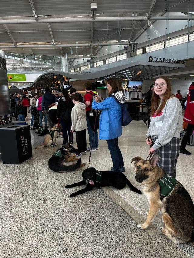 Tess Coffey and Lenny at an airport.