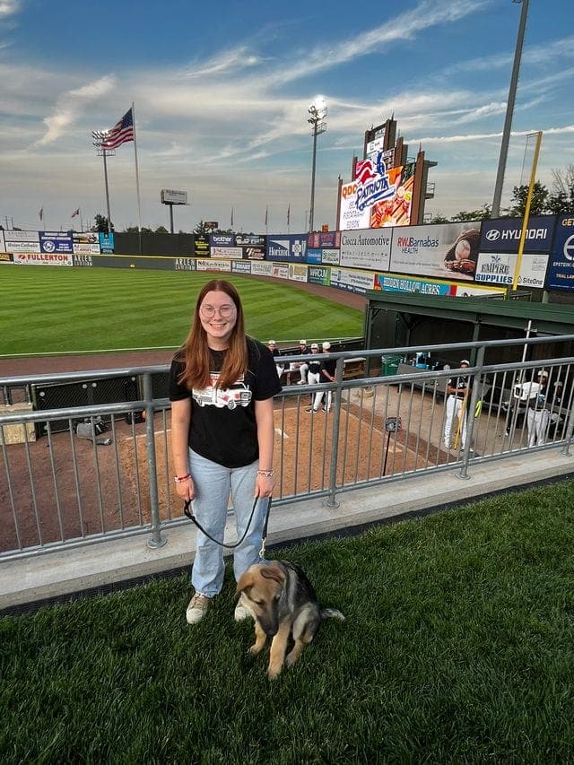 Tess Coffey and Lenny at a ballpark.